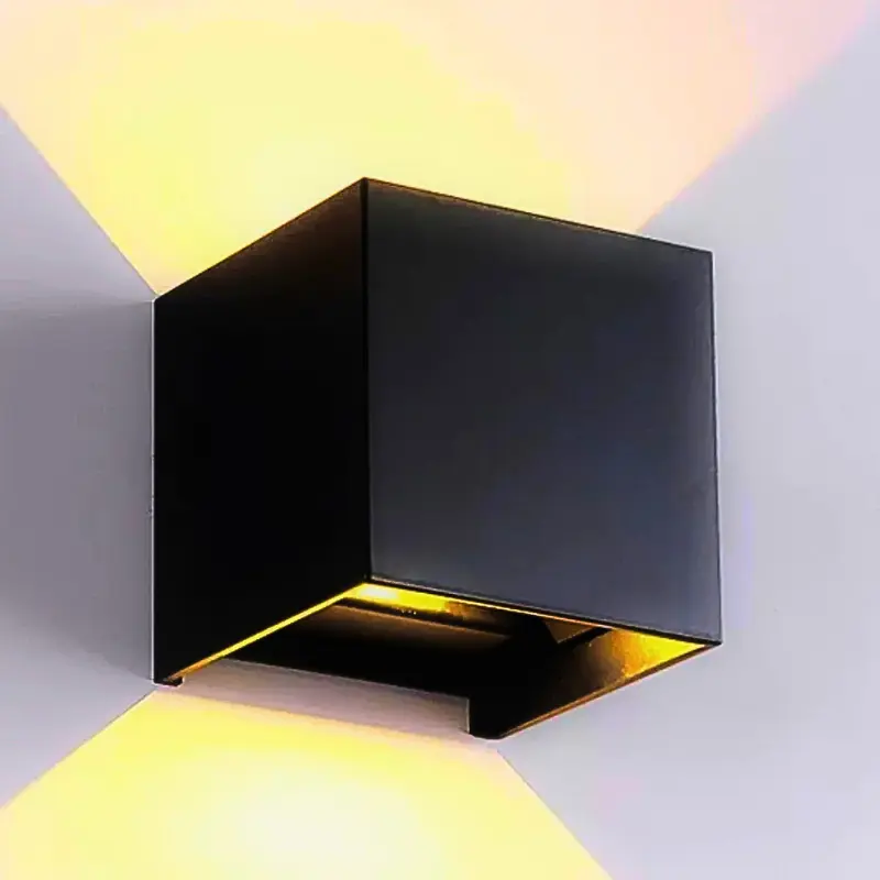 Black cube wall light casting light upward and downward